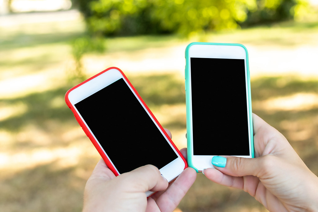 Two smartphones showing their glass screens